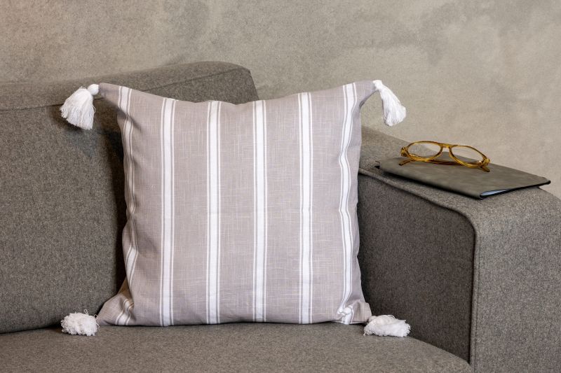 Φωτογραφία από  COTTON CUSHION 45Χ45 GREY WITH WHITE STRIPES AND TASSELS
